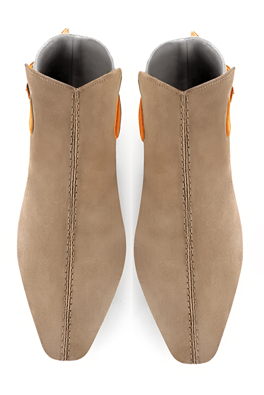 Tan beige, light silver and apricot orange women's ankle boots with buckles at the back. Square toe. Flat flare heels. Top view - Florence KOOIJMAN